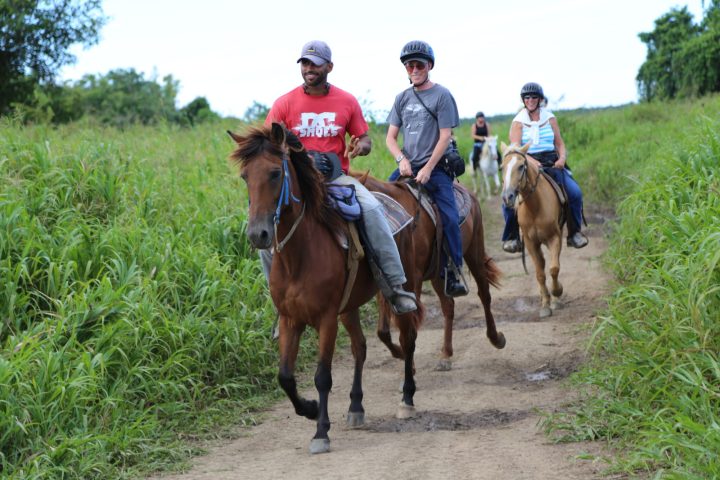 happy people on a horseback riding adventure