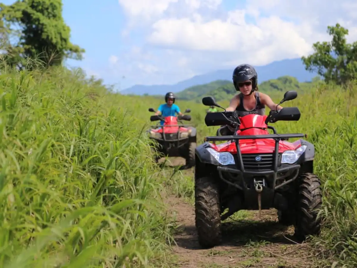 a man riding a motorcycle down a dirt road